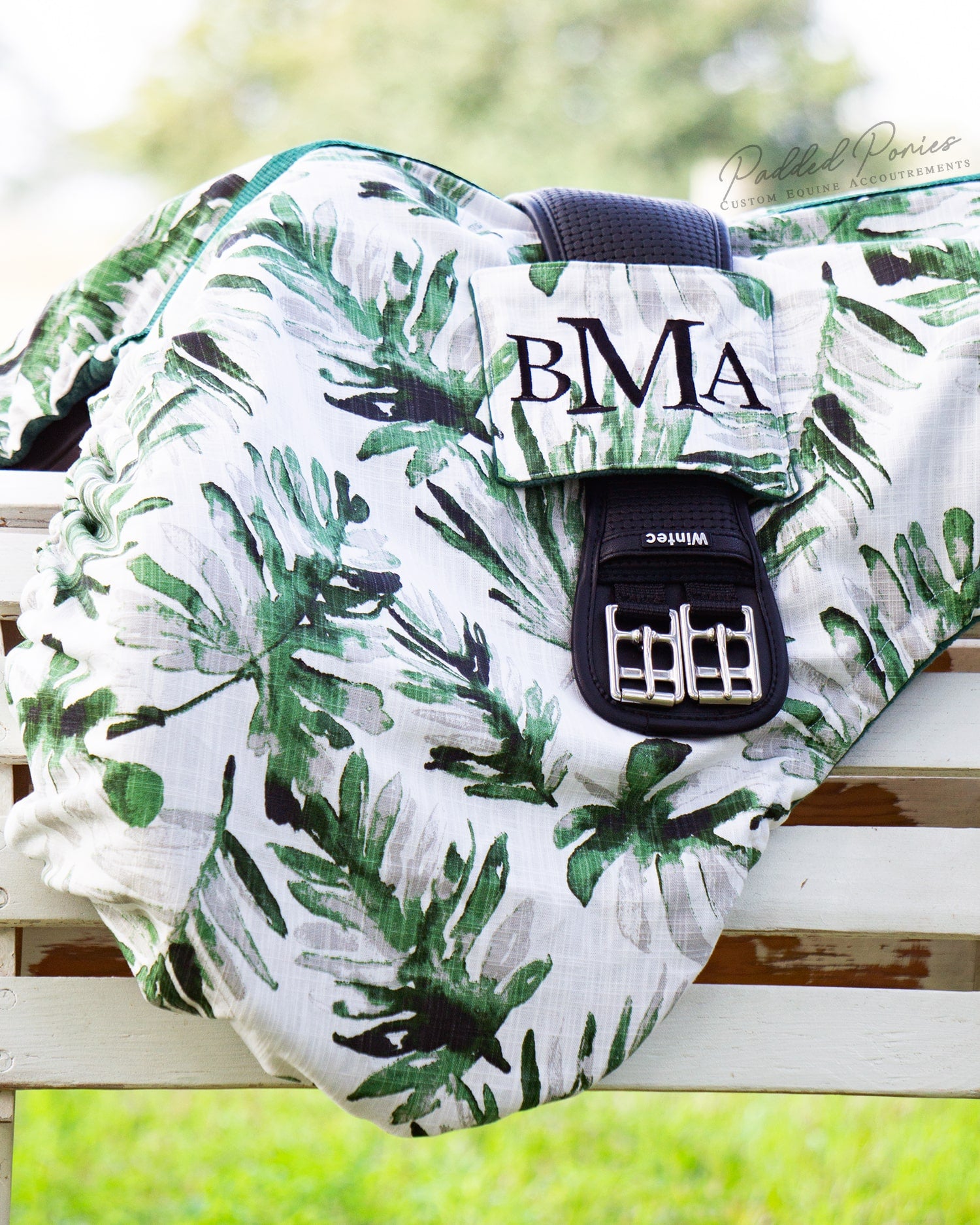 Green and white fronds print saddle cover with girth pocket and monogram