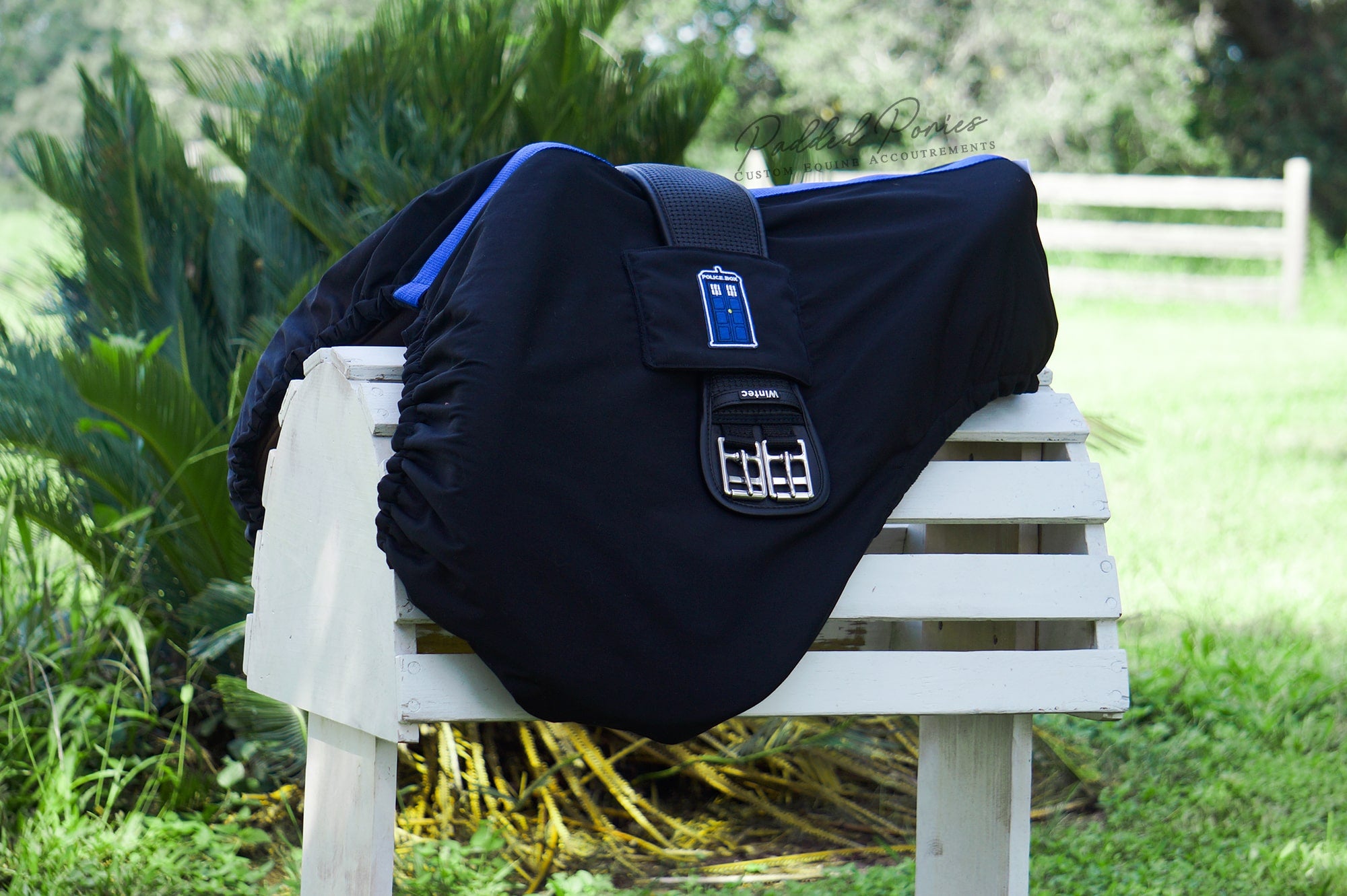 Black saddle cover with royal blue accents and Dr. Who Tardis patch